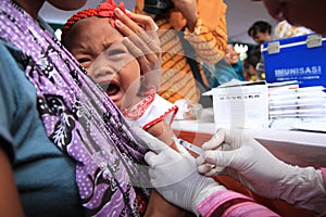 Surabaya indonesia, may 21, 2014. a health worker gave vaccinations to children