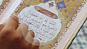 Surah Al Fatiha Rading-11 May 2022. young woman reading the Quran in Arabic 4K Video. close up to finger and Quran. Surah (Al