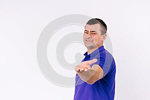A surdomute man with a happy smile shows his empty hand to the camera. White background and empty side space. photo
