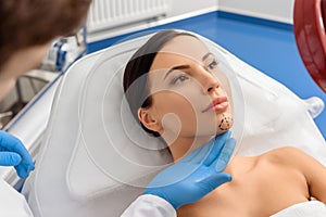 Sure woman looking at mirror before operation