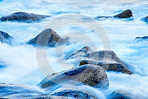 Surf of the atlantic ocean with crabs in long time exposure