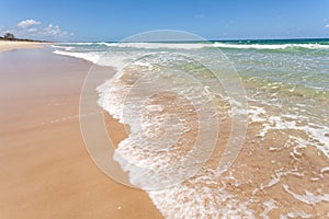 Surf Beach waves on tan sandy beach