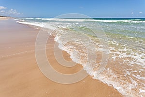 Surf Beach waves on tan sandy beach