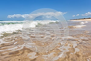 Surf Beach waves on tan sandy beach