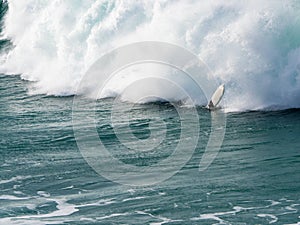 Surf board between the waves