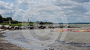 Surf boards lying rigged in the flat water