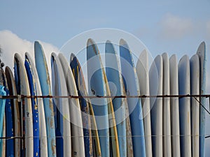 Surf boards stacked vertically