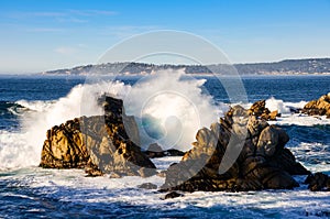 Surf breaking against rocks along the California coast