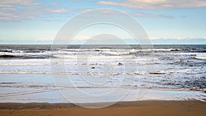 Surf breaking on Cambois Beach