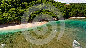 Surf coast on green bowl beach. Aerial view.