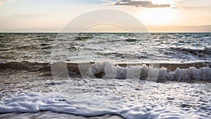 Surf at Dead Sea in winter twilight