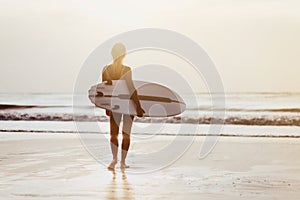 Surf girl with long hair go to surfing.
