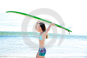 Surf girl with surfboard in beach shore