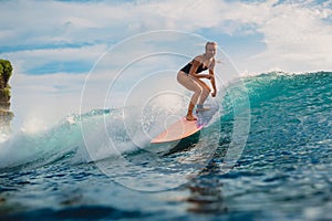 Surf girl on surfboard. Woman in blue ocean during surfing. Surfer on longboard and ocean wave