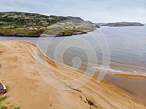 Surf line on the sandy beach of the Barents Sea.