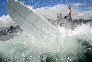 Surf longboarder off the lip