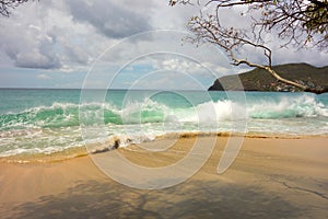 Waves meeting a pristine beach in the windward islands