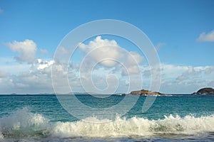 Surf pounding a beach on a sunny day in the southern Caribbean