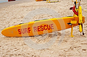 Surf rescue board on a white sand beach photo