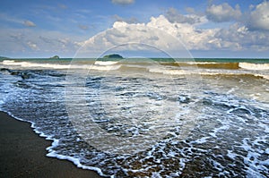 Surf on the sandy beach during sunset on the coast