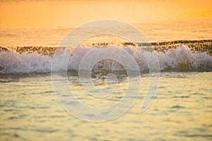 surf sea blured wave at golden light sunset beach background de