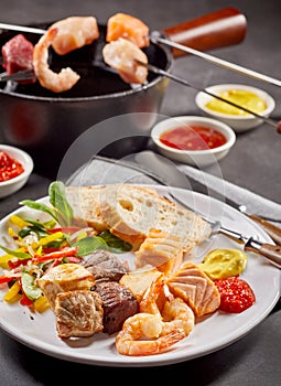 Surf and turf seafood and meat fondue