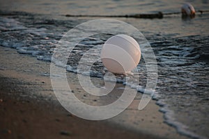 Surf and a white balloon. Dawn on the Mediterranean Sea. Kemer, Turkey