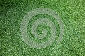 The surface of the artificial grass background with copy space. Top view of synthetic turf or fake grass material backdrop