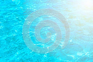 Surface of blue clear swimming pool. Water background pattern for background with sunlight