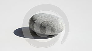 Surface and casts a small distinct shadow to the left indicating a