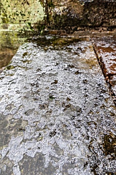 The surface of the cobblestones is covered with ice