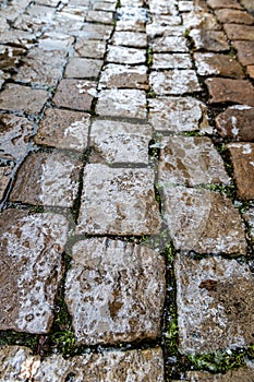 The surface of the cobblestones is covered with ice