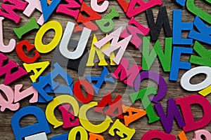 Surface covered with multiple colored wooden letters