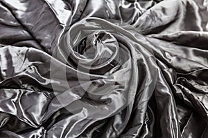 Surface of crumpled gray satin fabric. Textile industry and hobby. Close-up. Space for text