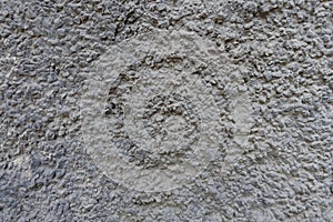 Surface of dusty wall with coarse gray roughcast finish