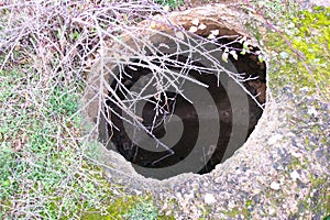 Surface access hole of a matmur (grain store) earth outside Imouzzer Kandar in the Moroccan province of Sefrou photo