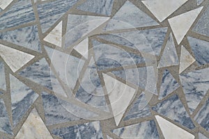 The surface of the floor or wall is made of marble tiles in the form of triangles