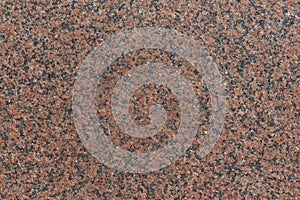 The surface of the granite slab is brown with speckles