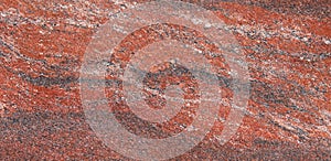 Surface of a granite stone. Red, white and black texture of a polished natural crystalline rock