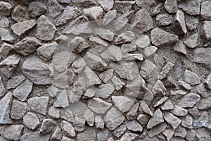 Surface of gray gravel pebble dash on the wall