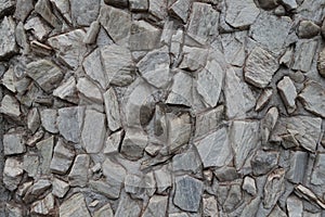 Surface of gray gravel pebble dash on the wall