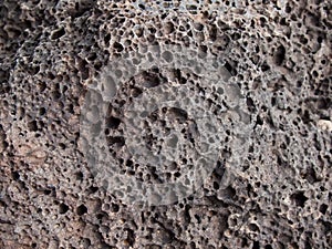 The surface of gray-pink porous volcanic rock