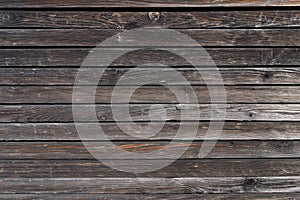 Surface of a heavily weathered planking of a facade made of wooden slats