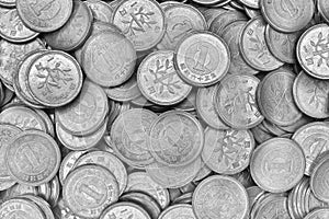 Surface of Japanese 1 one yen coins in close-up. Black and white light background or wallpaper. The backdrop on the theme of