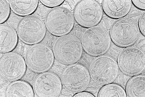 Surface of Japanese 1 one yen coins. Scratched money out of circulation. Close-up. Light monochrome black and white background or