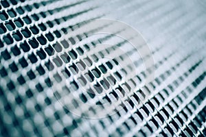 Surface of latticed metal fence. Stainless steel and aluminum light blur background. Macro texture