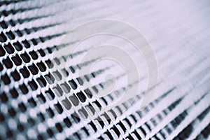 Surface of latticed metal fence. Stainless steel and aluminum light blur background. Macro texture