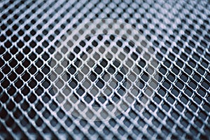 Surface of latticed metal fence. Stainless steel and aluminum light blur background. Macro texture