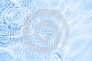 Surface of light blue transparent swimming pool water texture with circles on the water. Trendy abstract nature