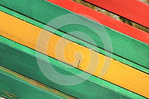 The surface of the nailed boards painted in green, yellow and red. Background picture